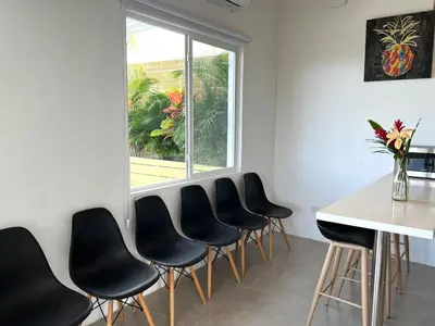 a room with a table and chairs and a window at Casa Blanca Manuel Antonio A2, Central, Pool, Gated in Manuel Antonio