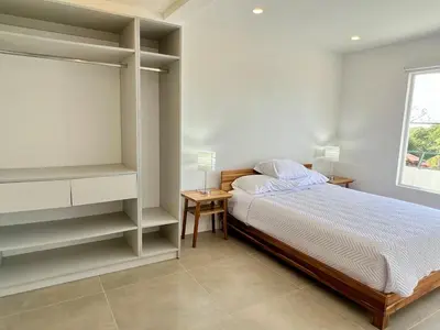 a bedroom with a bed and shelves and a window at Casa Blanca Manuel Antonio A2, Central, Pool, Gated in Manuel Antonio
