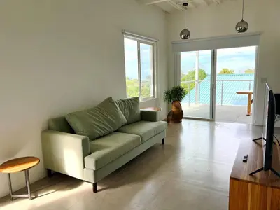 a living room with a couch and a table at Casa Blanca Manuel Antonio A2, Central, Pool, Gated in Manuel Antonio