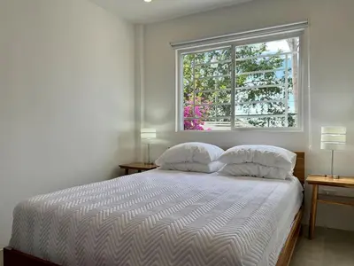 a bedroom with a bed with two lamps and a window at Casa Blanca Manuel Antonio A2, Central, Pool, Gated in Manuel Antonio