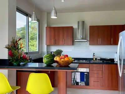 a kitchen with a bowl of fruit on a counter at Jaguar, 2 BR Penthouse in Villa Mar y Sol, Nature and Wildlife in Manuel Antonio