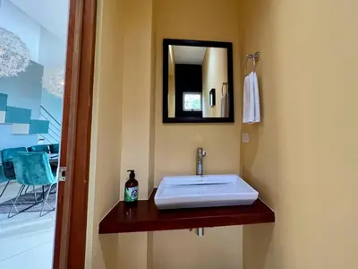 a bathroom with a sink and a mirror at Jaguar, 2 BR Penthouse in Villa Mar y Sol, Nature and Wildlife in Manuel Antonio
