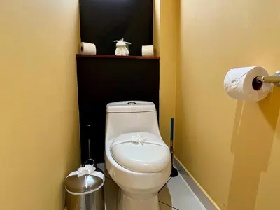 a bathroom with a white toilet in a room at Jaguar, 2 BR Penthouse in Villa Mar y Sol, Nature and Wildlife in Manuel Antonio