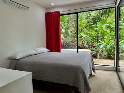 a bedroom with a bed and a large window at Villa Lapas, Central, Spacious and Lots of Wildlife in Manuel Antonio