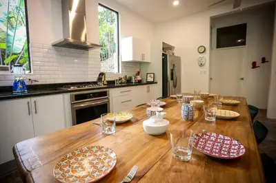 a kitchen with a wooden table with plates on it at Villa Lapas, Central, Spacious and Lots of Wildlife in Manuel Antonio