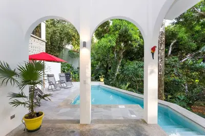 a house with a swimming pool and a courtyard at Villa Lapas, Central, Spacious and Lots of Wildlife in Manuel Antonio