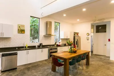 a large kitchen with a wooden table and chairs at Villa Lapas, Central, Spacious and Lots of Wildlife in Manuel Antonio