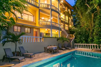 a house with a swimming pool in front of it at Castillo de Amber, 4 Aparts, 6 Bedrooms, Ocean Views, Central Location in Manuel Antonio