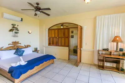 a bedroom with a bed and a piano at Castillo de Amber, 4 Aparts, 6 Bedrooms, Ocean Views, Central Location in Manuel Antonio