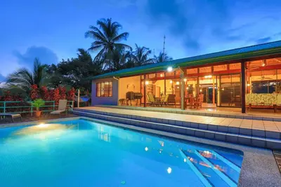 a swimming pool in front of a house at Casa Kilimanjaro Nature, Amazing Views and 6 Acres in Manuel Antonio