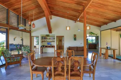 a dining room with a wooden table and chairs at Casa Kilimanjaro Nature, Amazing Views and 6 Acres in Manuel Antonio