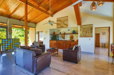 a large living room with couches and a kitchen at Casa Kilimanjaro Nature, Amazing Views and 6 Acres in Manuel Antonio