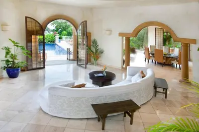 a large living room with a large white couch at Villa Vigia, beach views, 3 acres of privacy and tons of wildlife in Manuel Antonio