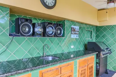 a kitchen with a sink and two speakers on the wall at El Perezoso, Studio Apartment w Views and Central Location in Manuel Antonio