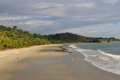 a group of people standing on a beach at El Perezoso, Studio Apartment w Views and Central Location in Manuel Antonio