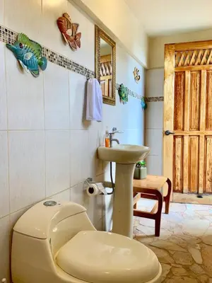 a bathroom with a toilet and a sink at El Perezoso, Studio Apartment w Views and Central Location in Manuel Antonio
