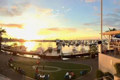 a view of a marina at sunset with a soccer field at El Titi, 1 Bedroom Ocean View Apartment, Central Location in Manuel Antonio