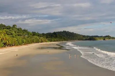 a group of people standing on a beach at El Titi, 1 Bedroom Ocean View Apartment, Central Location in Manuel Antonio