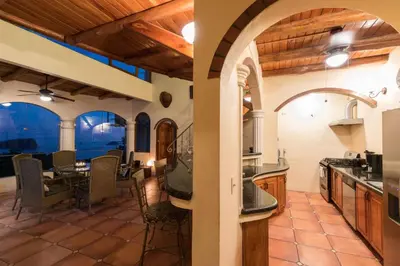 an open kitchen and dining room with a table and chairs at El Congo, 2BR Apartment w Great Ocean Views and Central Location in Manuel Antonio