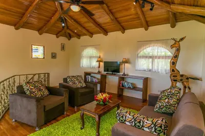 a living room with a giraffe statue on the wall at El Congo, 2BR Apartment w Great Ocean Views and Central Location in Manuel Antonio