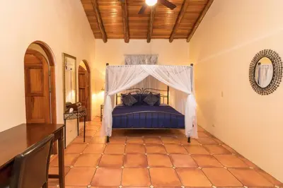 a bedroom with a blue bed with a canopy at El Congo, 2BR Apartment w Great Ocean Views and Central Location in Manuel Antonio