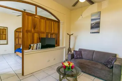 a living room with a couch and a table at El Capuchin, 2BR Ocean View Apartment, Central Location in Manuel Antonio