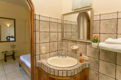 a bathroom with a sink and a mirror at El Capuchin, 2BR Ocean View Apartment, Central Location in Manuel Antonio