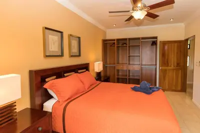 a bedroom with a bed and a ceiling fan at Casa Sophia A Cozy, Treetop, Sea View Gem in Quepos