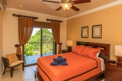 a bedroom with a bed and a window at Casa Sophia A Cozy, Treetop, Sea View Gem in Quepos
