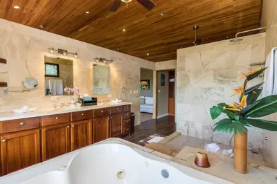 a large bathroom with a tub and a sink at Casa Sophia A Cozy, Treetop, Sea View Gem in Quepos
