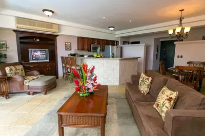 a living room with a couch and a table at Shana Residences 310 Sea View Condo Walk to beach in Manuel Antonio