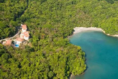 an aerial view of a house on a hill next to a lake at Shana Residences 310 Sea View Condo Walk to beach in Manuel Antonio