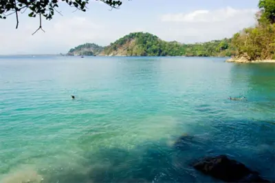 a large body of water with people swimming in it at Shana Residences 310 Sea View Condo Walk to beach in Manuel Antonio