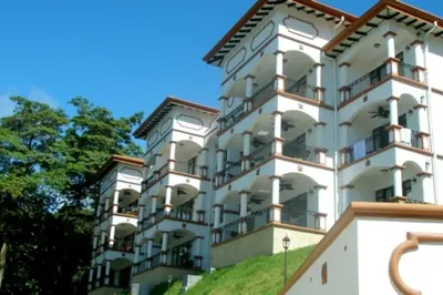 a large white building with balconies on it at Shana Residences 310 Sea View Condo Walk to beach in Manuel Antonio