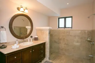 a bathroom with a sink and a shower with a mirror at Shana Residences 310 Sea View Condo Walk to beach in Manuel Antonio