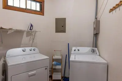 a laundry room with two washing machines and a window at Jungle Creek all 4 villas up to 19 people in Manuel Antonio