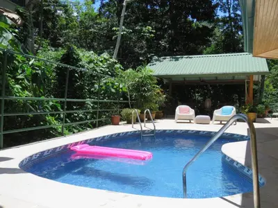 a swimming pool with a pink inflatable at Mono Vista At Jungle Creek Chill out in the Jungle in Manuel Antonio