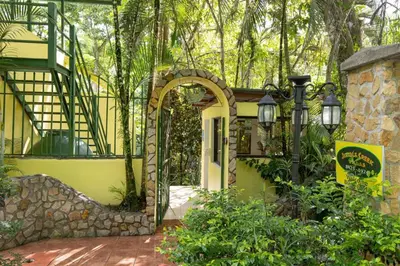 an entrance to a yellow house with an archway at Alma Pacifica, Charming, secure and lots of wildlife in Manuel Antonio