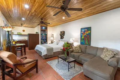 a living room with a bed and a couch at El Gekko spacious studio in Manuel Antonio
