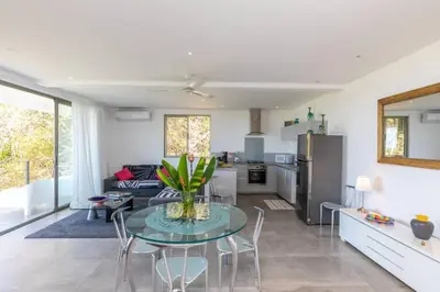a kitchen and living room with a table and chairs at Guanacaste, 2 Bedroom Apartment in La Maison Blanche in Manuel Antonio