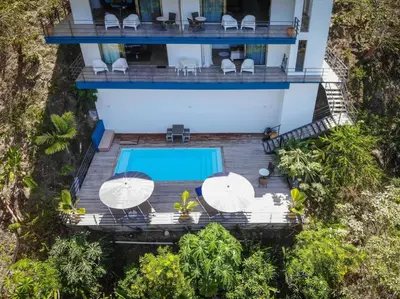 an aerial view of a villa with a swimming pool at Guanacaste, 2 Bedroom Apartment in La Maison Blanche in Manuel Antonio