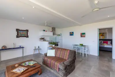 a living room with a couch and a table at La Maison Blanche Nicoya, Pool, Views, and Wildlife in Manuel Antonio