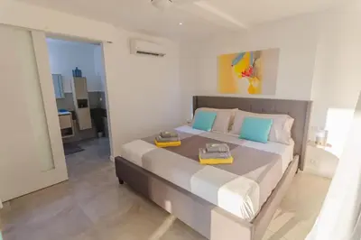 a bedroom with a large bed with two boxes on it at La Maison Blanche Nicoya, Pool, Views, and Wildlife in Manuel Antonio