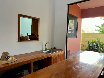 a kitchen with a sink and a mirror on the wall at Finca Terra, Private Country Home, Mountain Views and Pool in Manuel Antonio