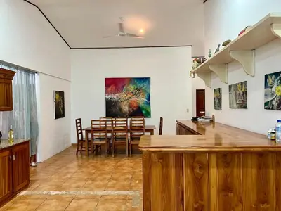 a kitchen and dining room with a painting on the wall at Finca Terra, Private Country Home, Mountain Views and Pool in Manuel Antonio
