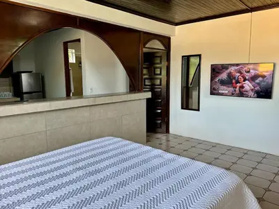 a bedroom with a bed and a large mirror at Casa Blanca Manuel Antonio B3, Central, Pool, Gated in Quepos