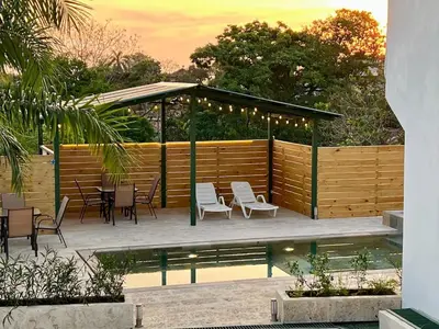 a gazebo with chairs and tables next to a pool at Casa Blanca Manuel Antonio B3, Central, Pool, Gated in Quepos
