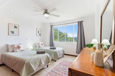 a bedroom with two beds and a window at Mir4 Stunning OceanView 2BD Over Tamarindo in Tamarindo