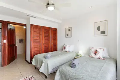 a bedroom with two beds and a bathroom at Mir4 Stunning OceanView 2BD Over Tamarindo in Tamarindo