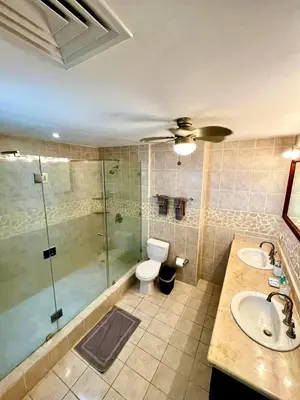 a bathroom with a shower and a toilet and a sink at Mir4 Stunning OceanView 2BD Over Tamarindo in Tamarindo